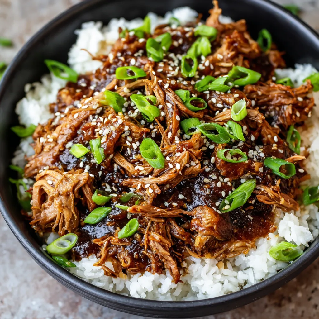 A bowl of slow cooker Asian shredded pork.