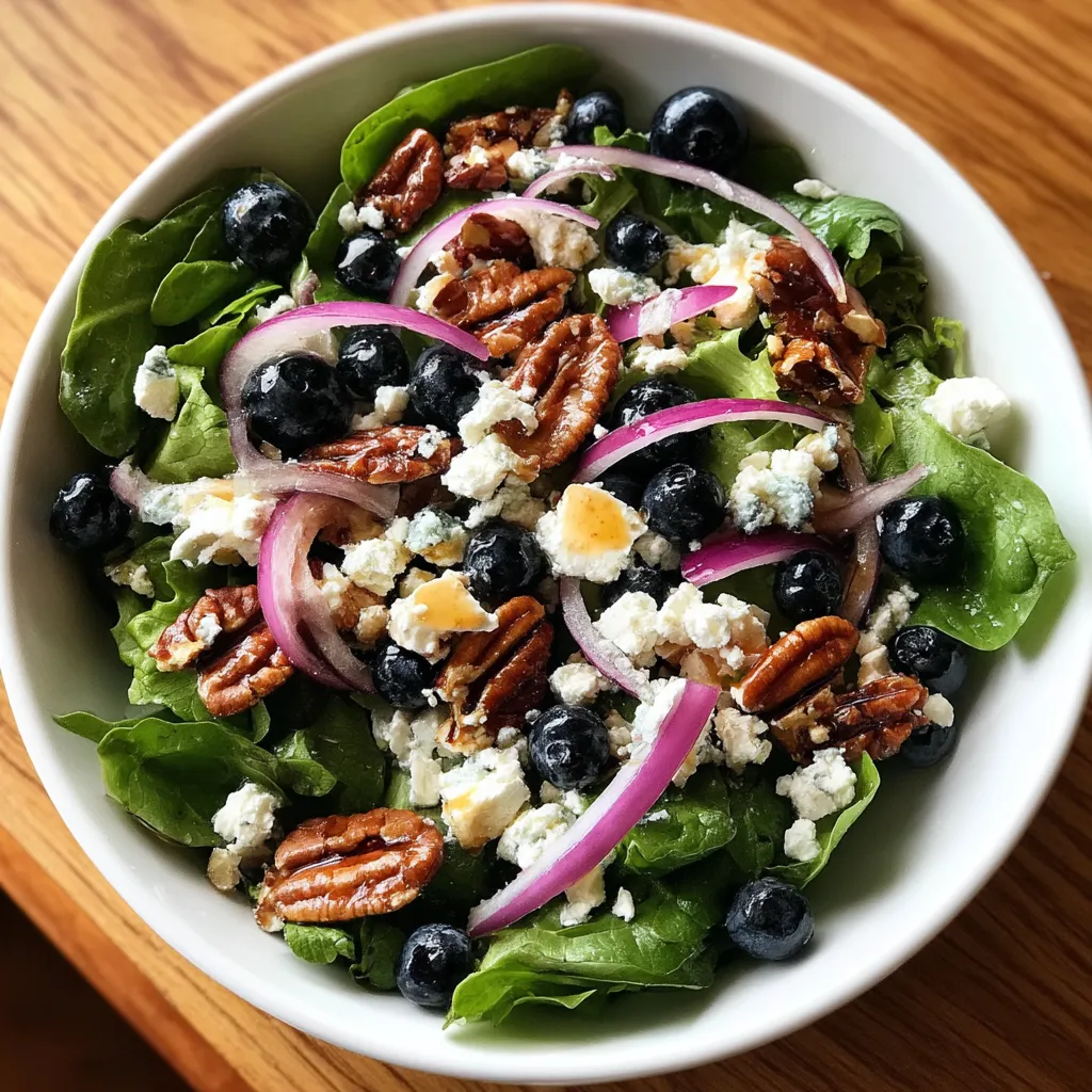 A bowl of blueberry goat cheese salad.