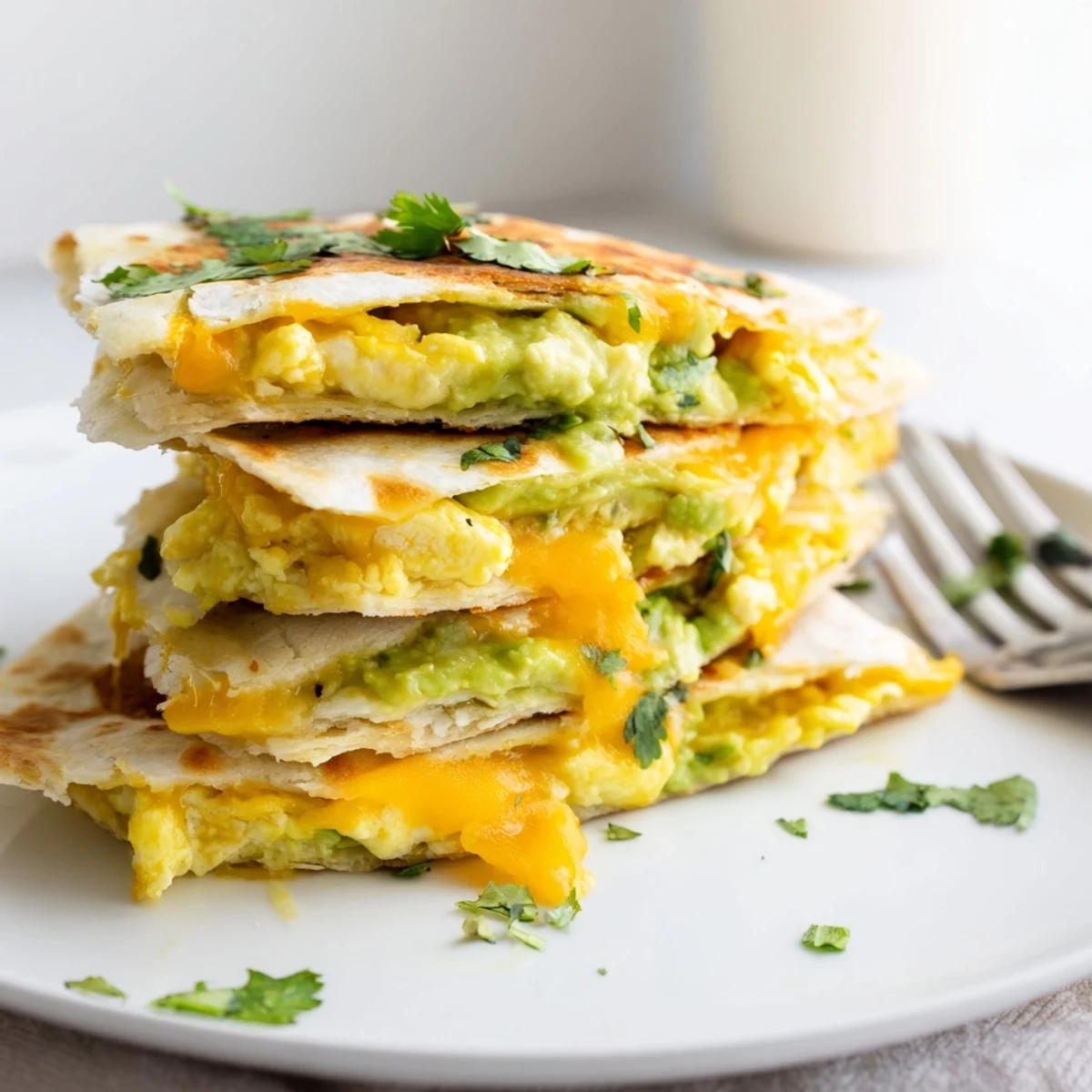 Mouthwatering Avocado Egg Cheddar Quesadillas, crispy and warm, perfect for breakfast gatherings.