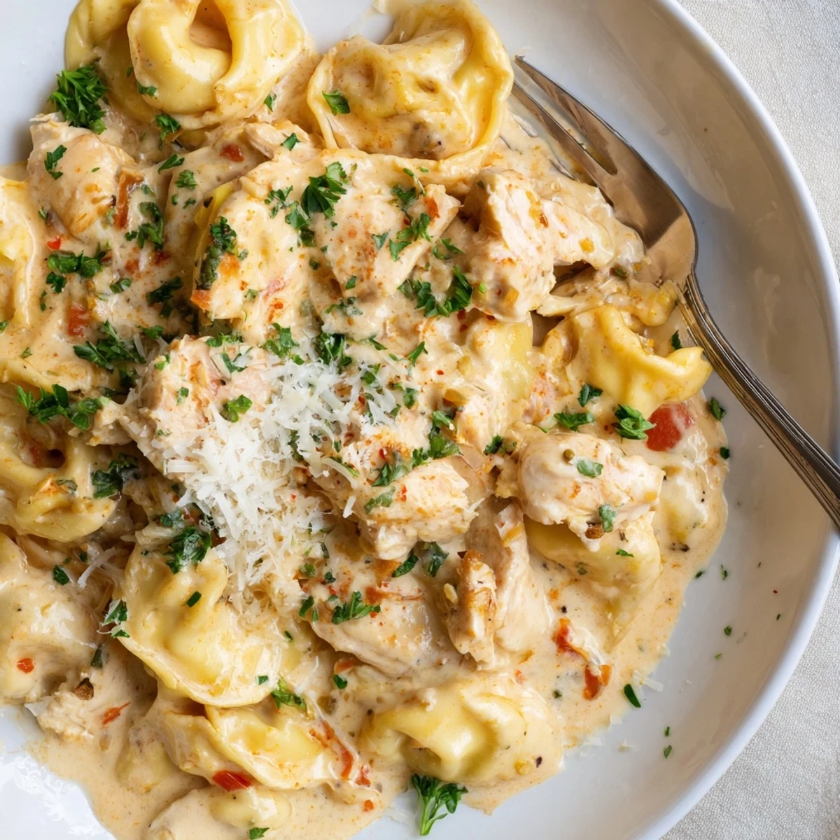 Savor the rich Zesty Cajun Garlic Parmesan Chicken Tortellini, perfect for weeknight dinners.