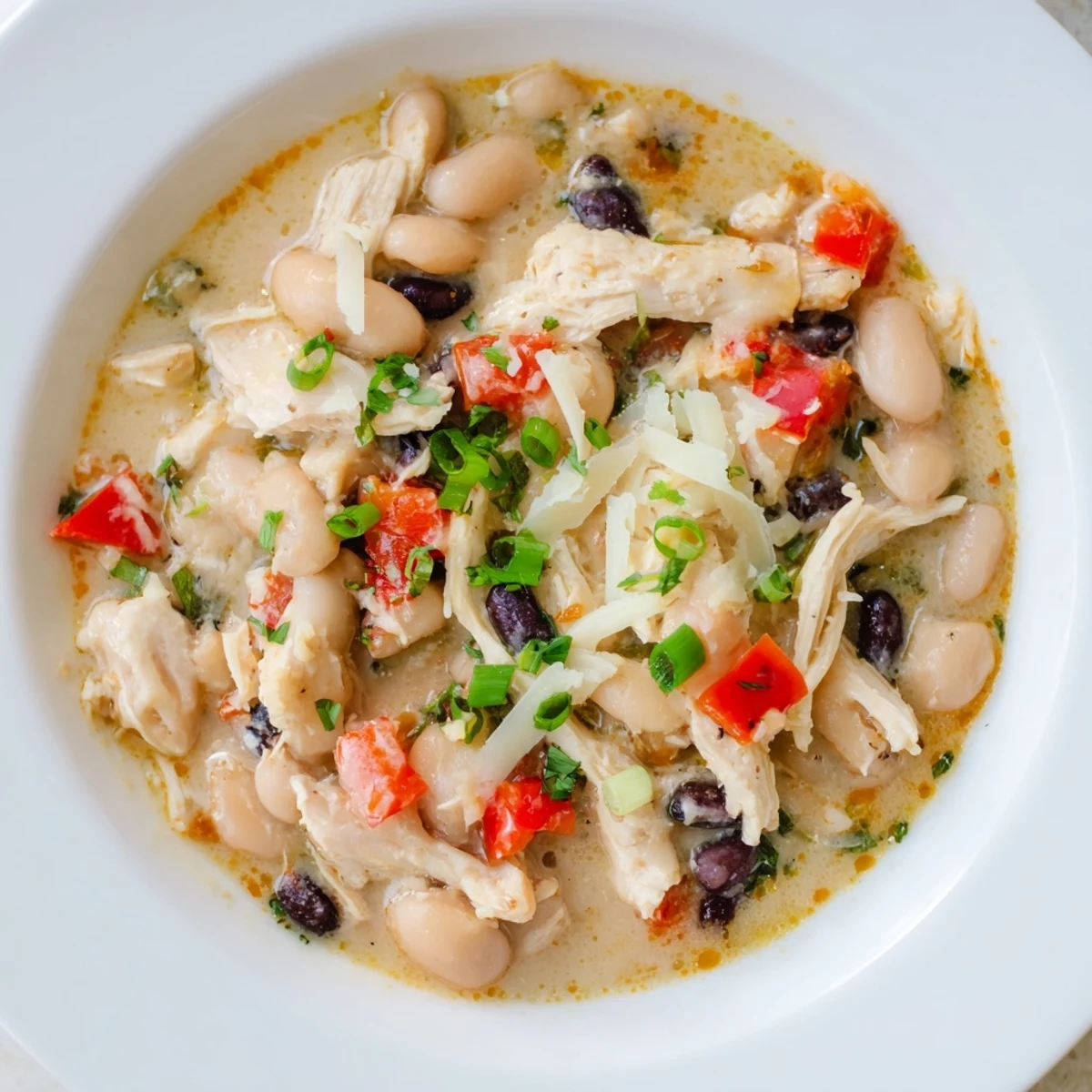Close-up of a hearty slow cooker white chicken chili with black beans, perfect for a cozy dinner.