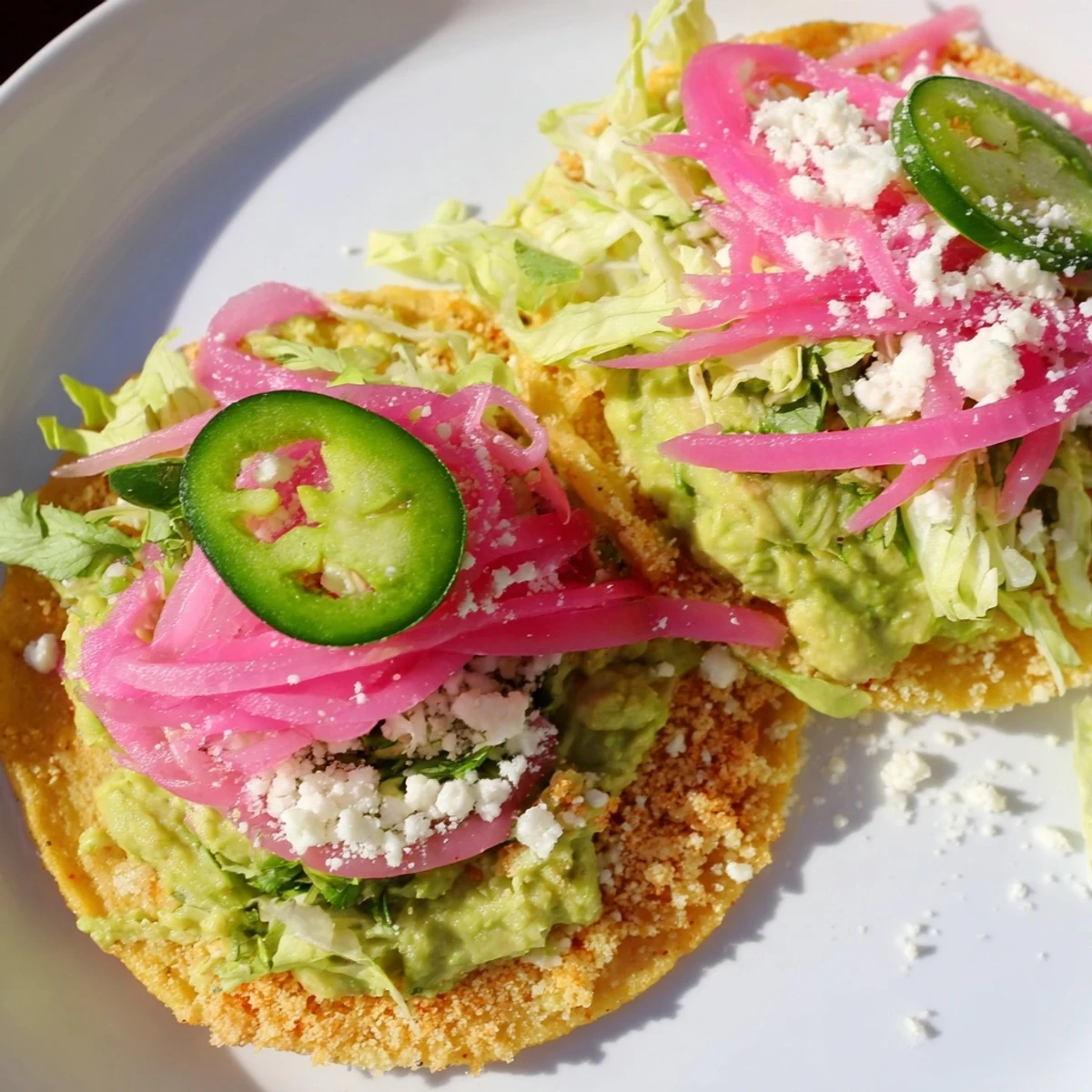 Brightly colored 5-Minute Pickled Red Onion Tacos featuring a creamy avocado crema, perfect for a quick dinner.
