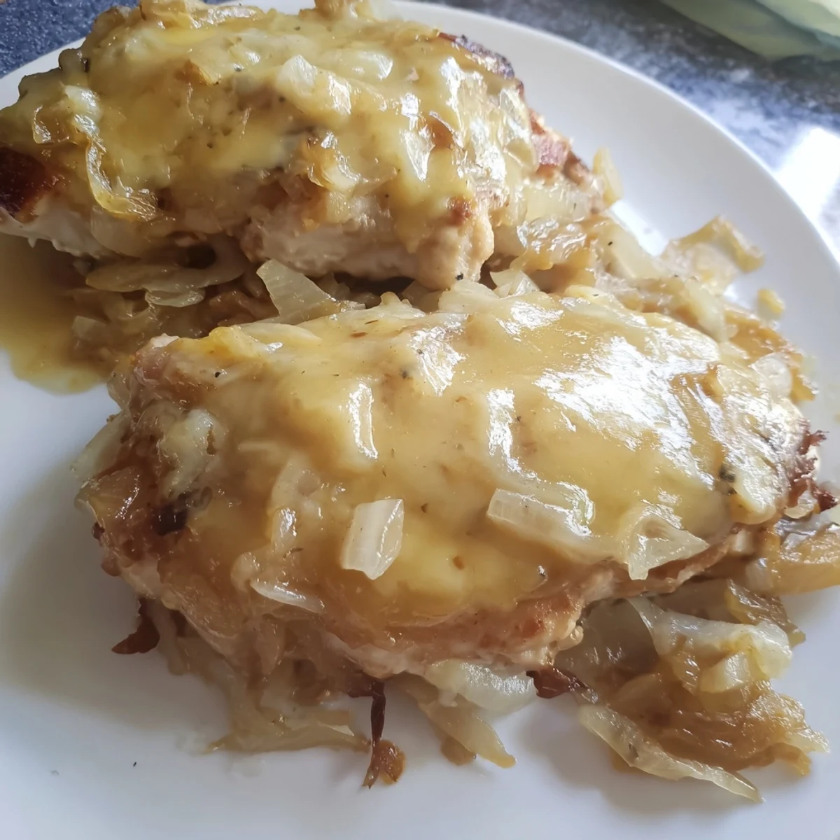 Instant Pot French Onion Chicken: golden, bubbly Gruyère cheese melting over tender chicken and crusty bread.