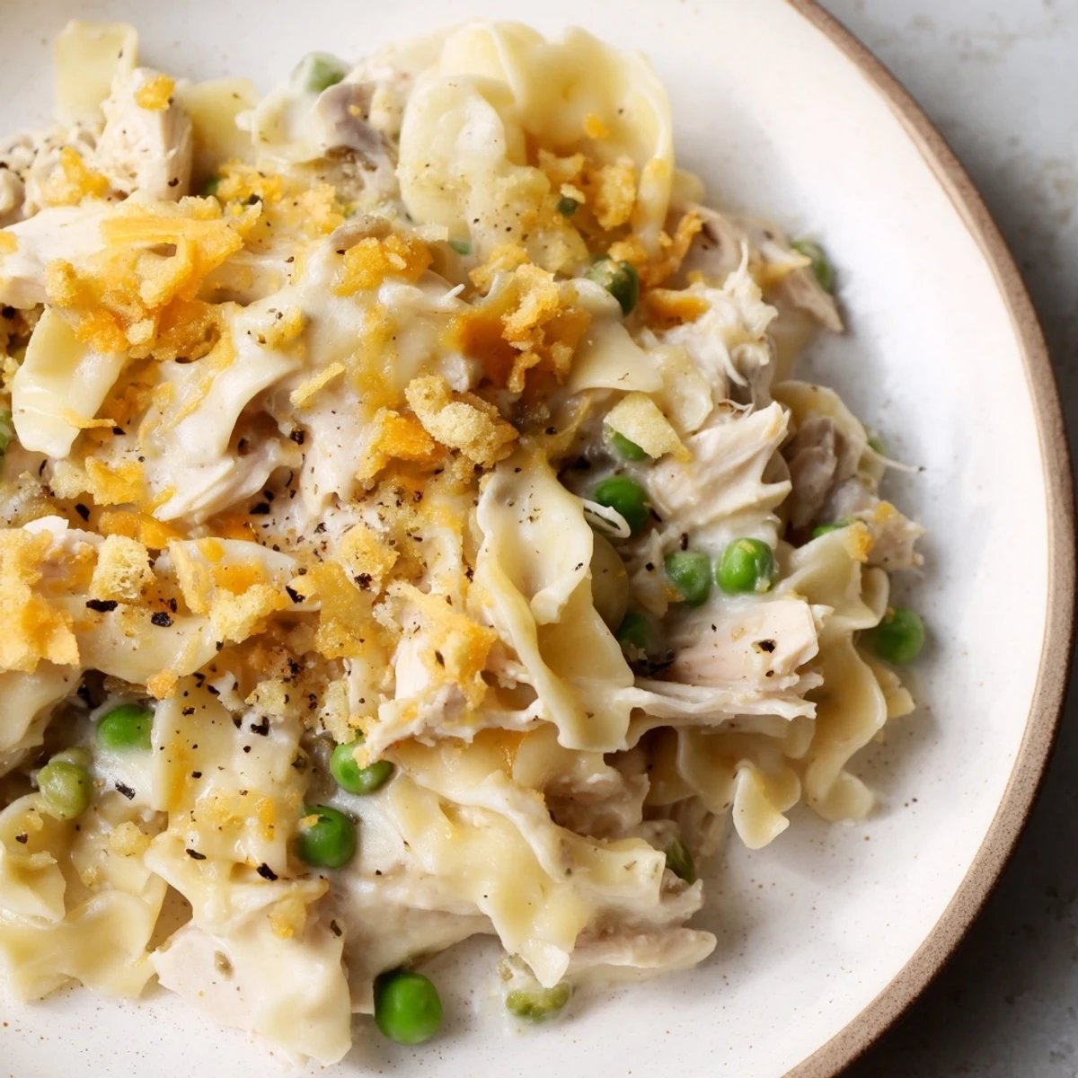 Golden, bubbly Creamy Tuna Noodle Casserole with Ritz cracker topping, ready to serve, deliciously comforting.