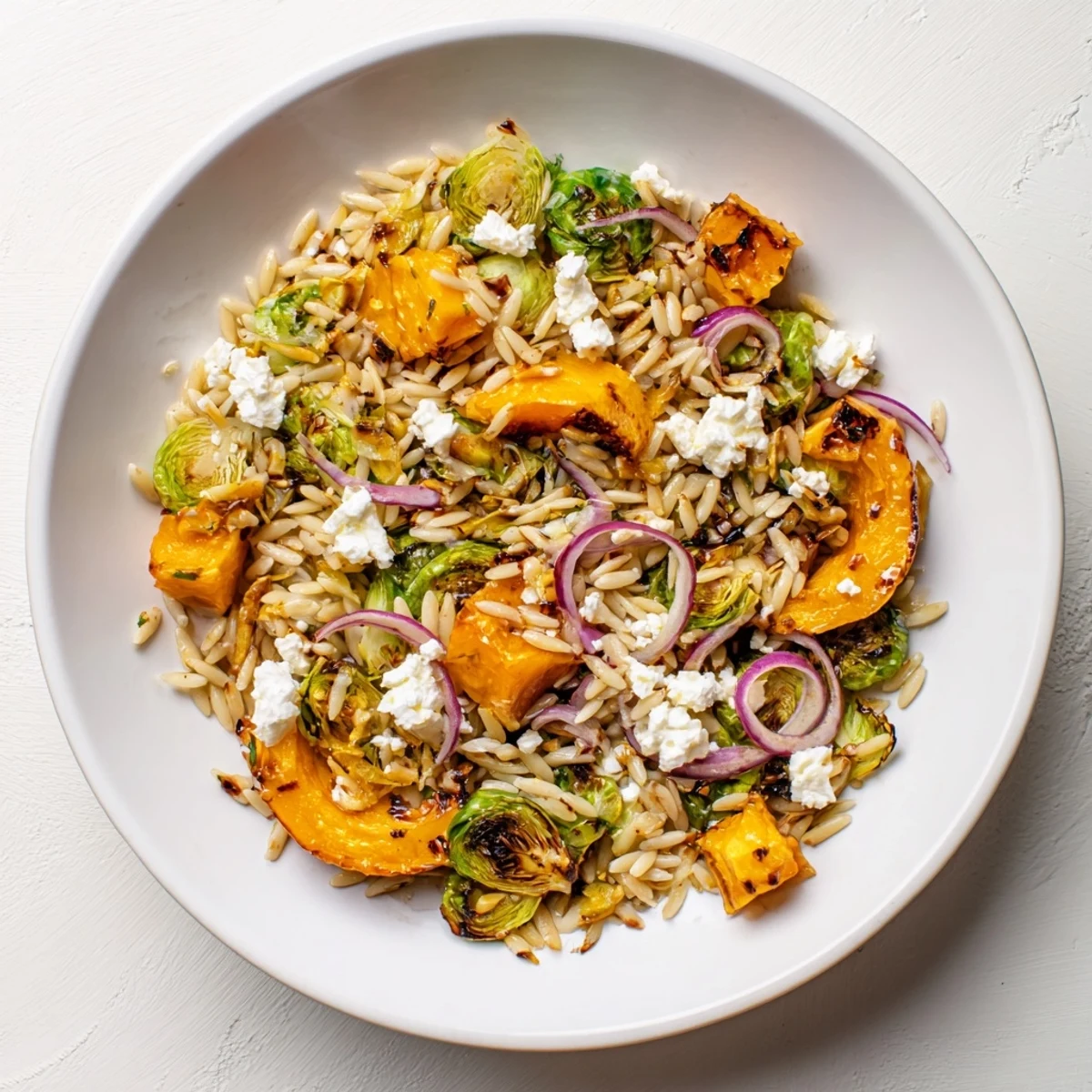 Vibrant Best Fall Harvest Orzo Salad with roasted butternut squash and creamy goat cheese, ready to eat.