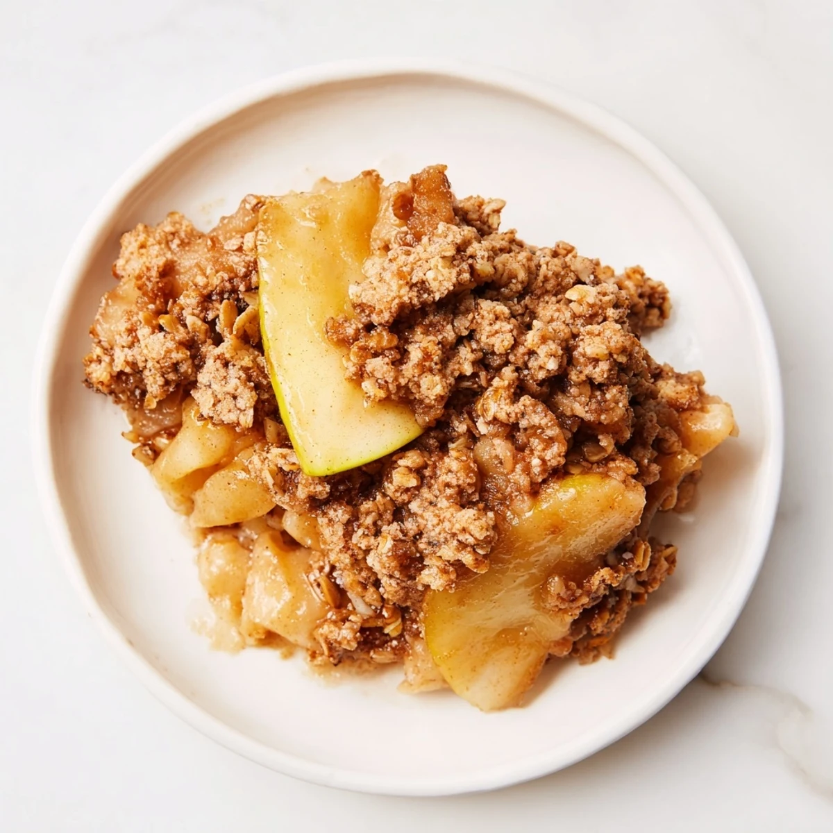 Warm and bubbling Best Apple Crisp, a dessert's sweet aroma fills the kitchen, ready to be enjoyed.