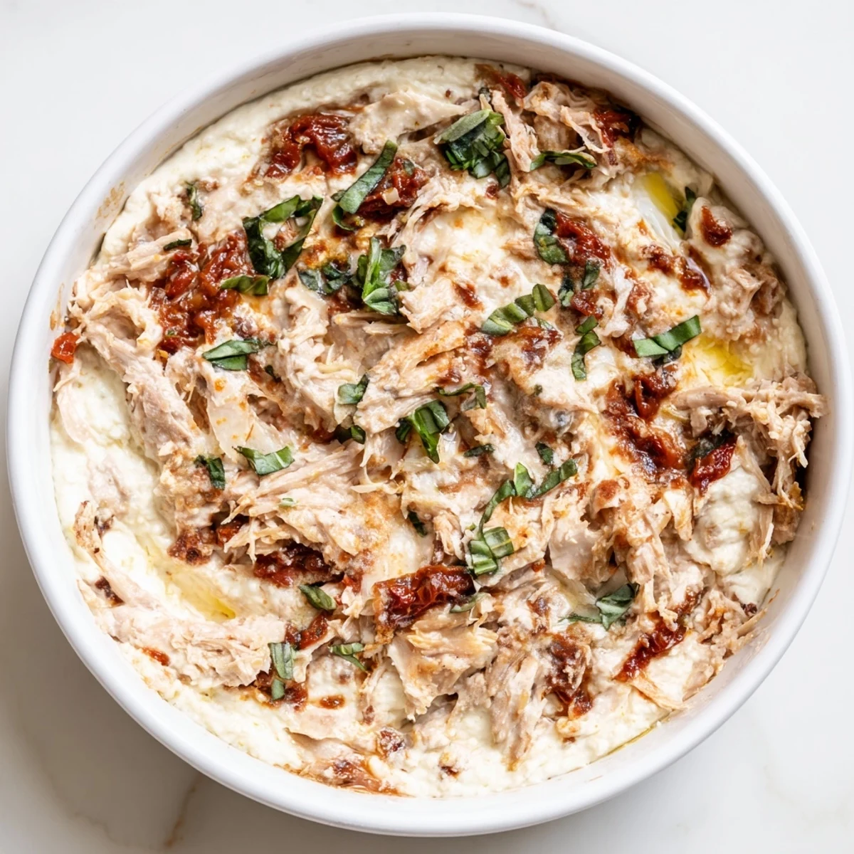 Creamy, baked Lightened Marry Me Chicken Dip, with golden-brown cheese, perfect for dipping and sharing.