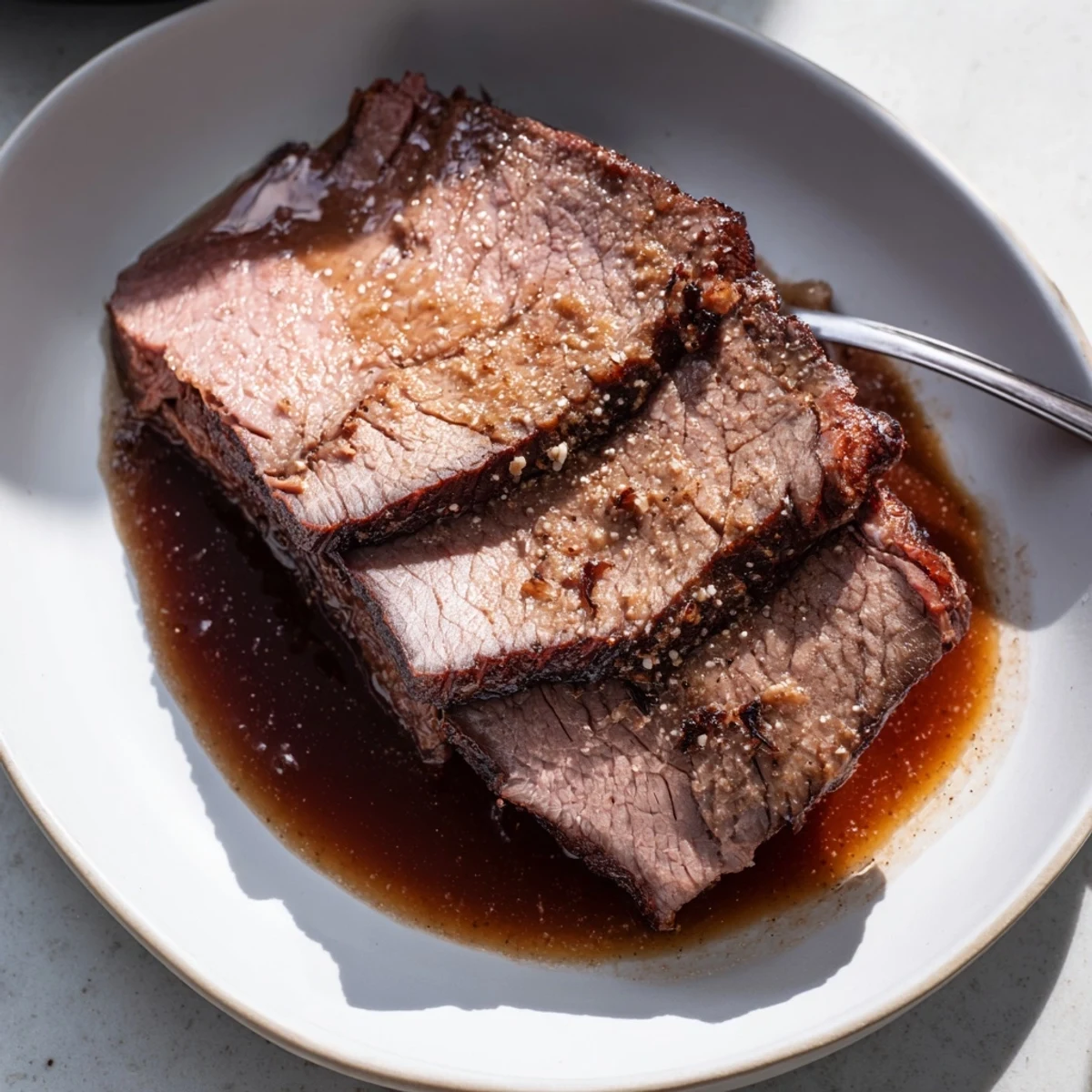 Fork-tender Budget Holiday Chuck Roast, nestled in its rich, flavorful cooking juices, perfect for dinner.