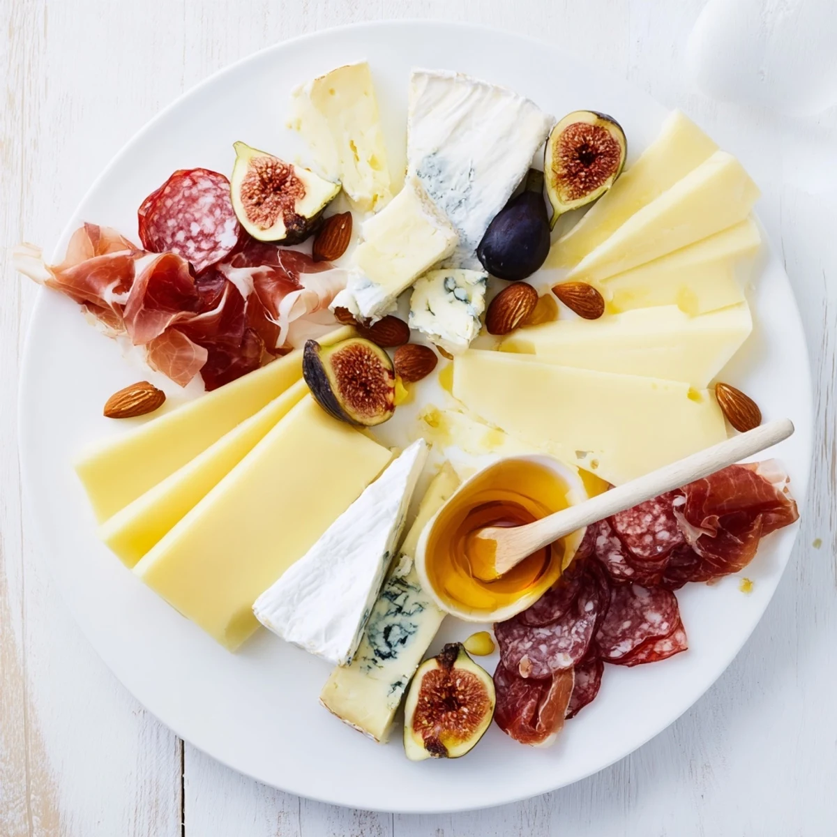 Plateau des Rois Mages Gourmand: a beautifully arranged sharing platter with cheeses, meats, and sweet treats.