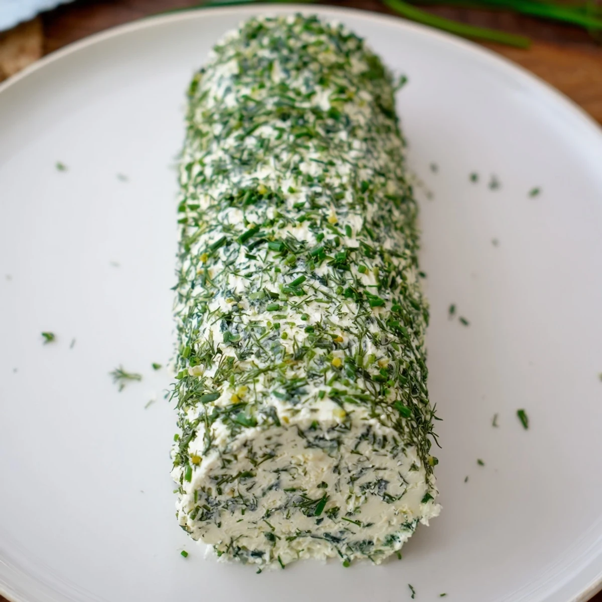 Herb-Coated Cheese Log with vibrant herbs and crackers, ready for a delicious American appetizer.