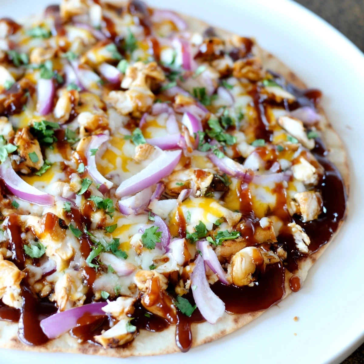 Crispy BBQ Chicken Flatbread with melty cheese and fresh cilantro, perfect for dinner tonight.