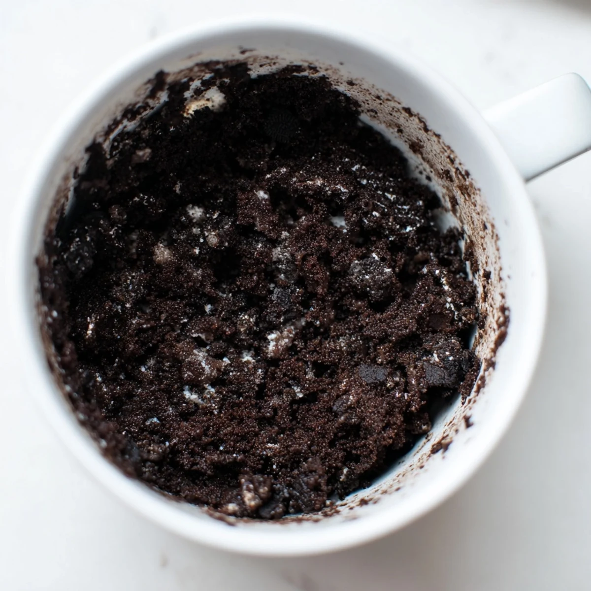 Steaming hot Oreo Mug Cake, a decadent dessert that's easy to make in your microwave.