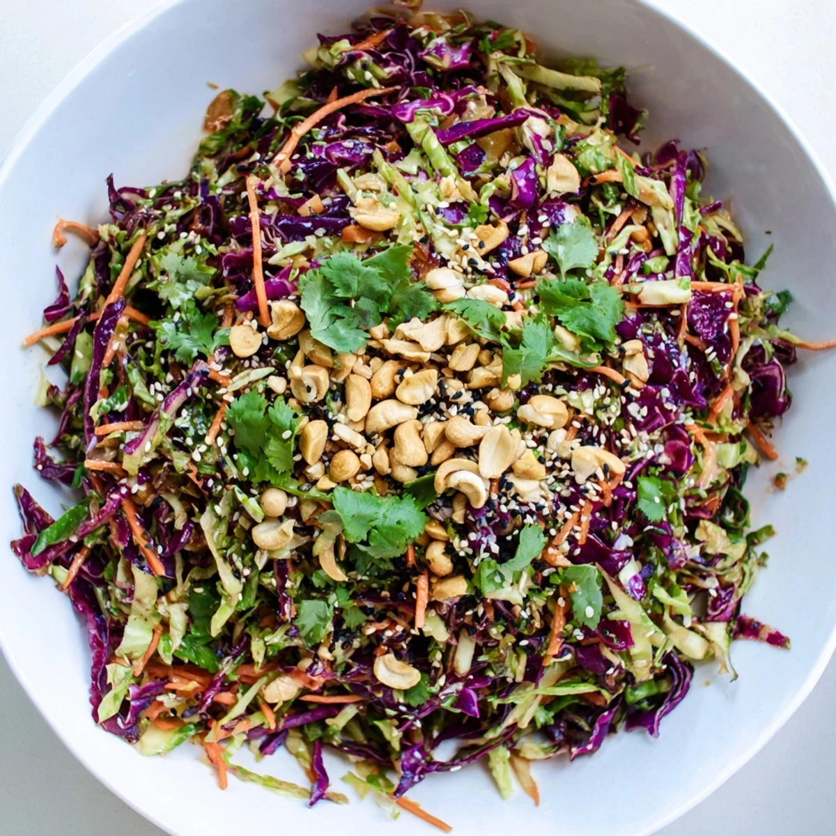 Tangy sesame dressing coats every shred in this Asian Cabbage Salad, perfect for pairing with grilled chicken or enjoying as a light vegan meal.