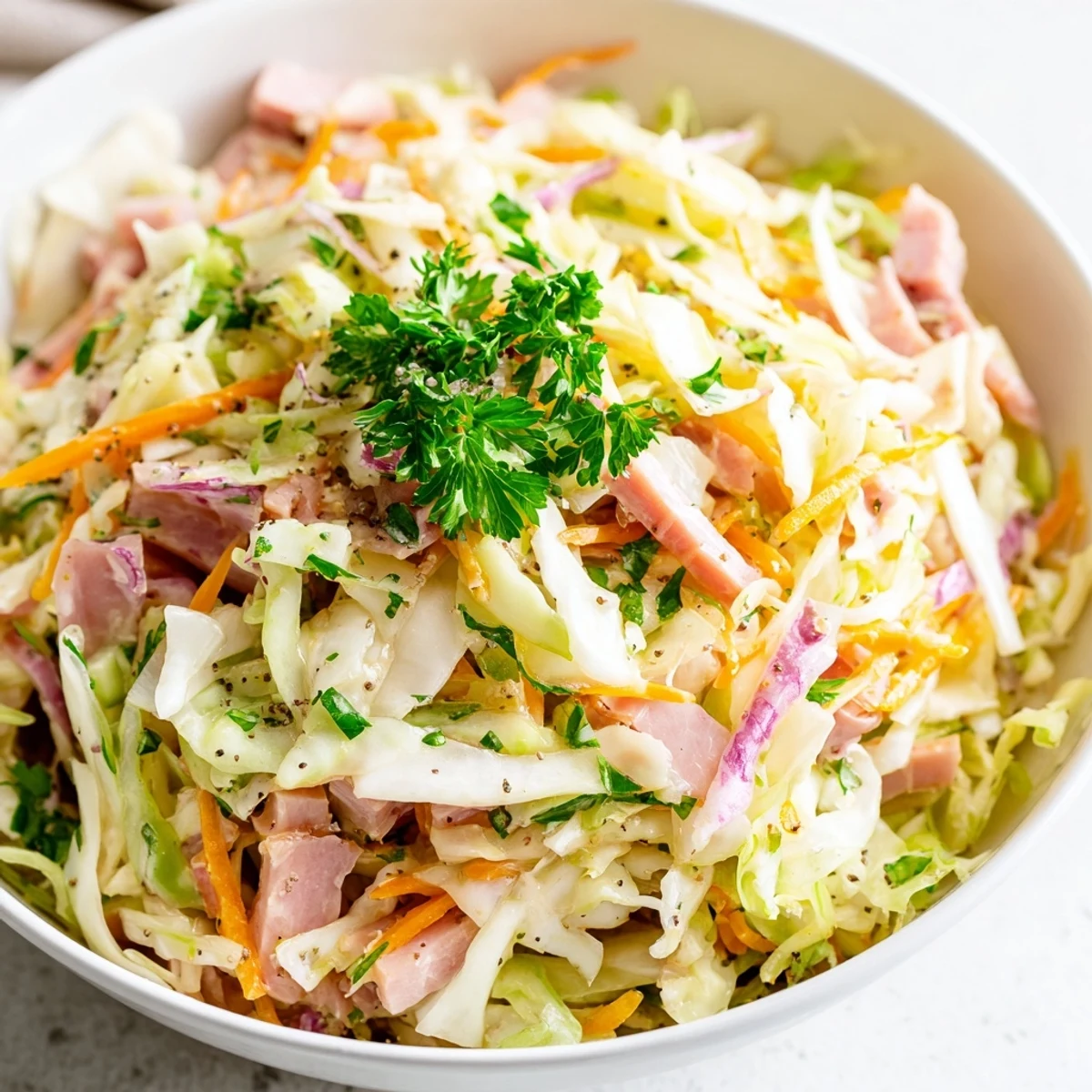 Perfectly balanced with sweet honey and sharp Dijon, this German Cabbage Coleslaw With Shredded Ham offers a hearty, crunchy bite for any meal.