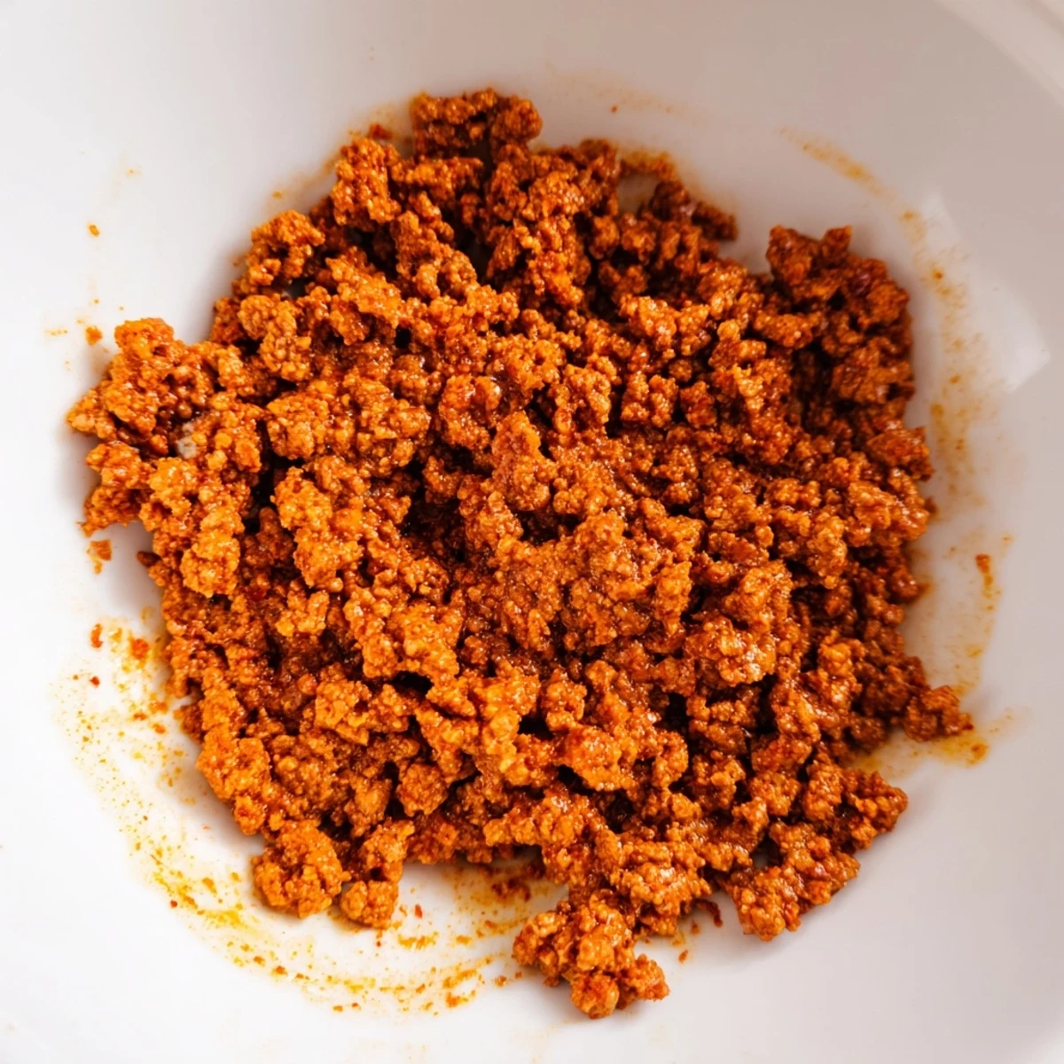 Gluten-free Easy Big Mac in a Bowl topped with tomatoes, red onion, and sesame seeds, ready for a quick dinner.