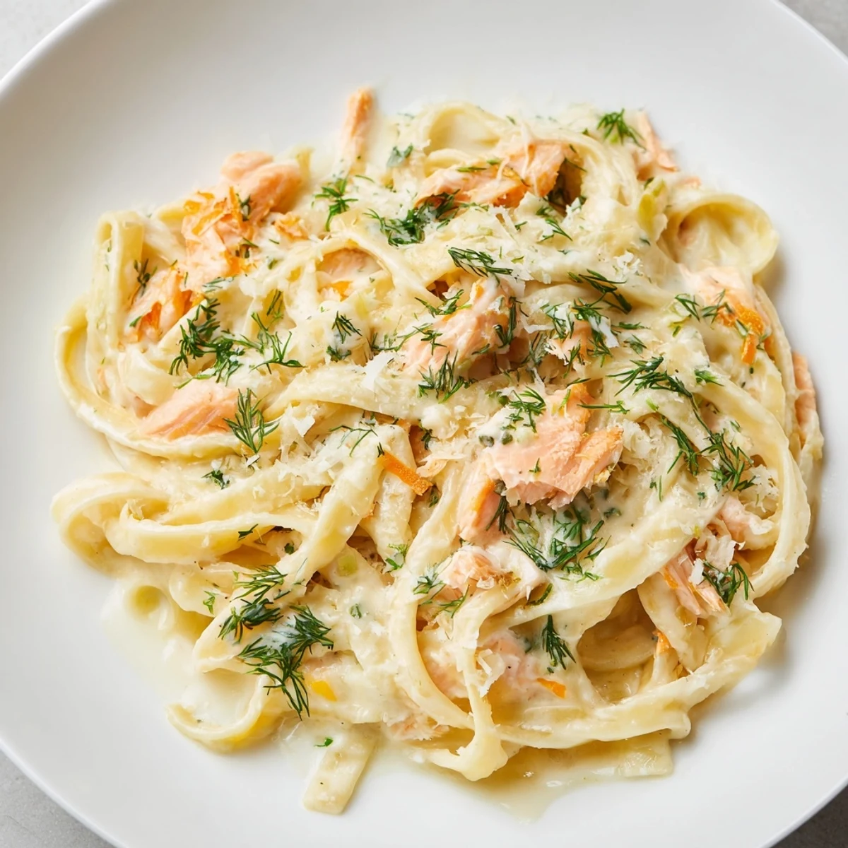Creamy salmon pasta with grated Parmesan and lemon juice, perfect for a quick weeknight dinner.