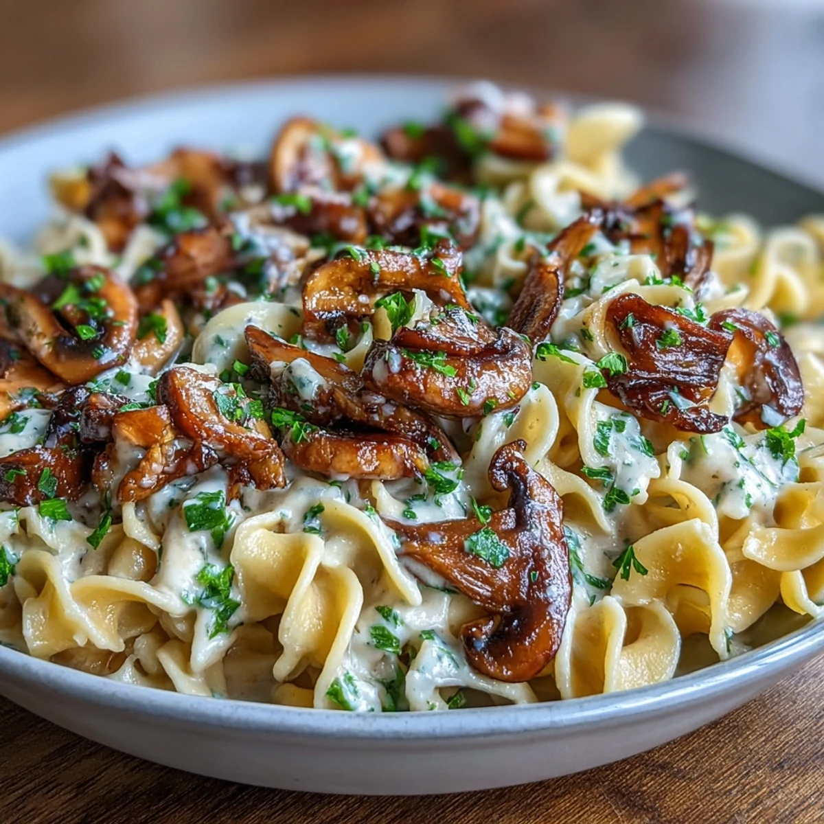 Savory mushroom stroganoff with caramelized onions and sour cream sauce spooned over warm egg noodles.