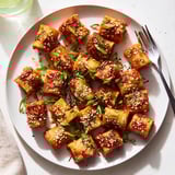 Golden-brown baked pasta bites drizzled in spicy miso-chili glaze for a flavorful snack.