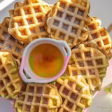 Crispy waffle quarters with a sweet maple syrup dip, ideal for a delicious breakfast treat.