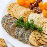 Perfect for snacking: a layered display of Gourmet Crackers, garnished with herbs and dried fruits.