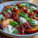 Savory prosciutto, sweet peaches, and fresh basil top this elegant Peach Burrata Prosciutto Salad.