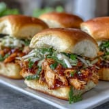 Juicy Apple BBQ Chicken Mini Sandwiches piled high, ready to be devoured.