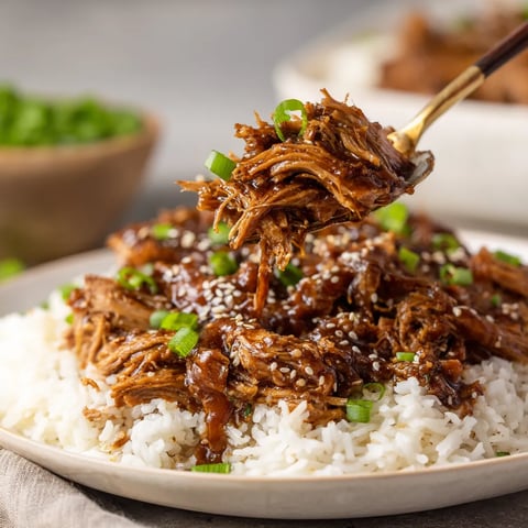 A plate of slow cooker Asian shredded pork with rice.