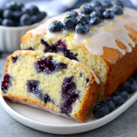 A slice of blueberry lemon loaf with glaze.