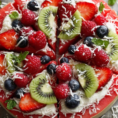 A slice of watermelon pizza with kiwi and blueberries.
