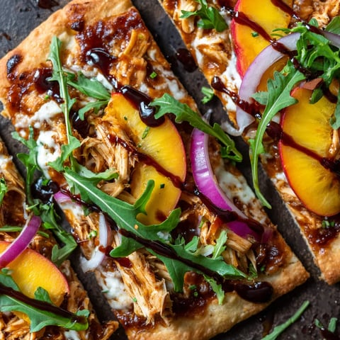 A flatbread with peach BBQ chicken toppings.
