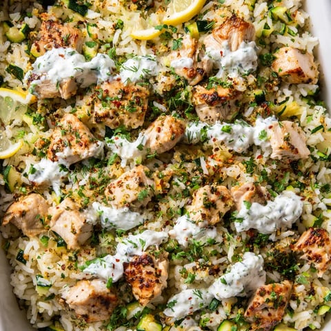 A dish of rice with chicken and lemon.