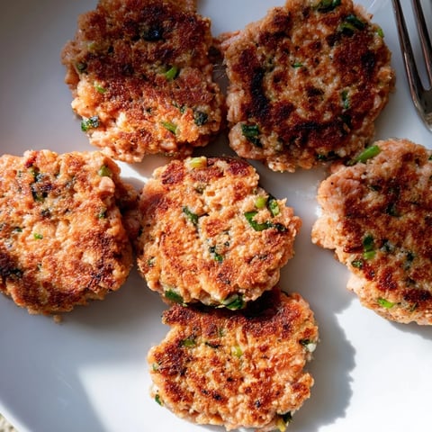 Tender garlic ginger salmon patties, golden-brown, perfect for any light meal.  