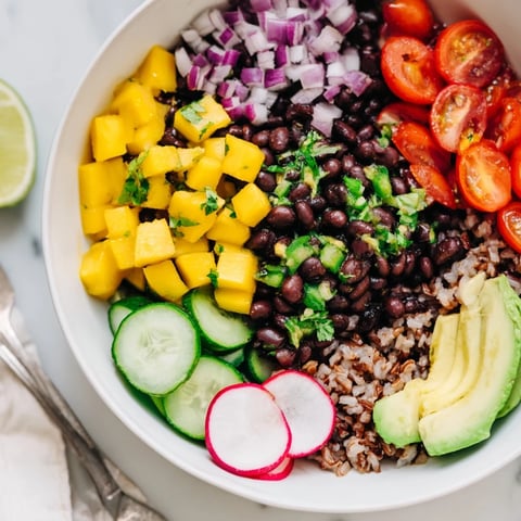 Fresh, colorful Mango Salsa Black Bean Bowls topped with creamy avocado slices.  
