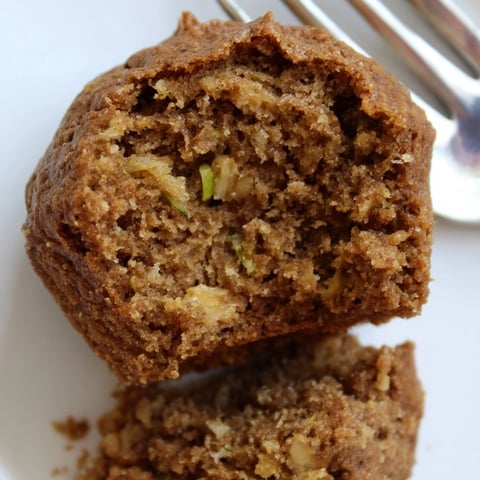 Moist protein cinnamon zucchini muffins baked to golden perfection, ideal for breakfast.  
