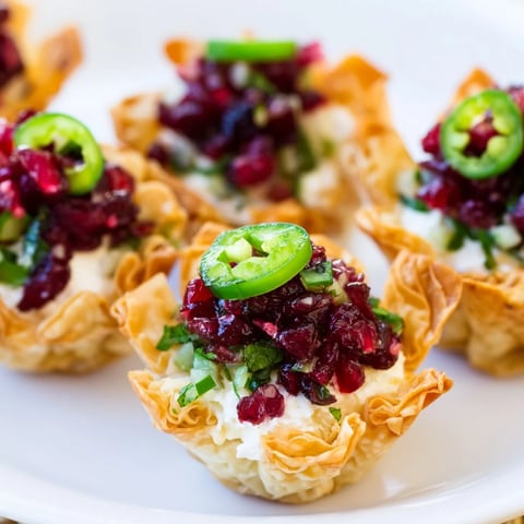 Delicious cranberry jalapeño dip tarts served in golden phyllo shells for appetizers.  