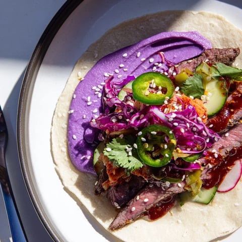 Vibrant Global Street-Food Fusion Tacos showcase colorful toppings and savory marinated meat.  