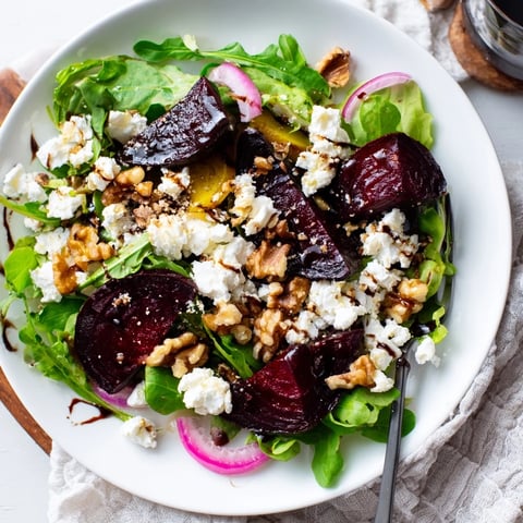 Vibrant roasted beet and goat cheese salad topped with crunchy walnuts and balsamic dressing.  