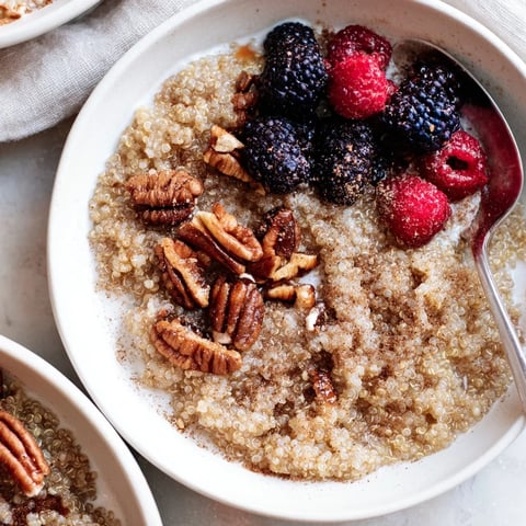 Delicious Maple Pecan Breakfast Quinoa topped with fresh berries and toasted nuts.  