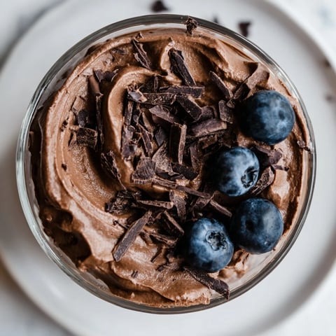 Rich and creamy No-Bake Cottage Cheese Chocolate Mousse, swirled and topped with fresh, juicy berries.