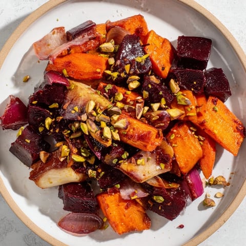 Vibrant Balsamic Glazed Root Vegetables gleaming with a sweet, tangy glaze, topped with crunchy pistachios.