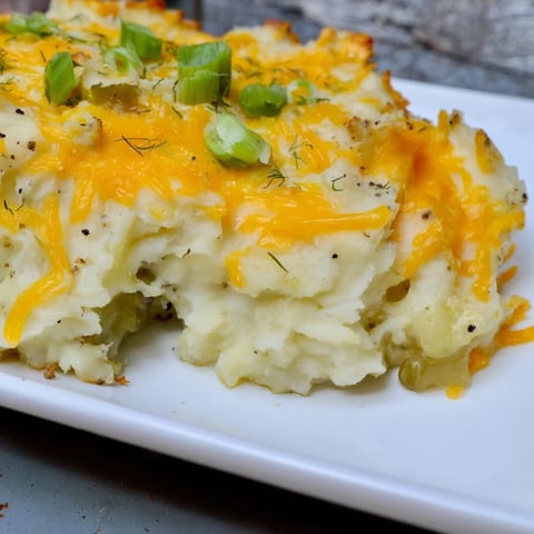 Golden-brown Dill Pickle Mashed Potato Bake, bubbly with cheddar cheese, a delicious side dish.