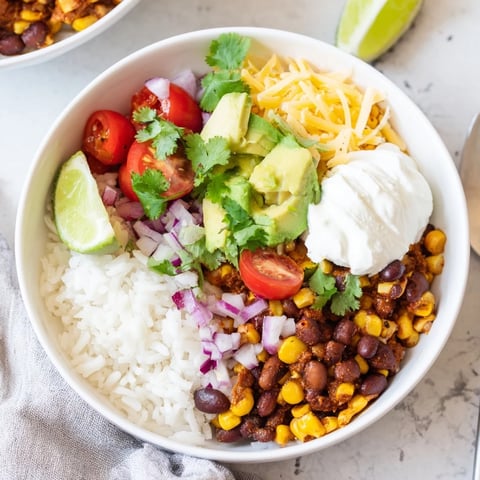 Fluffy rice, seasoned beans, and sweet corn brimming from these flavorful Rice, Bean, and Corn Burrito Bowls.