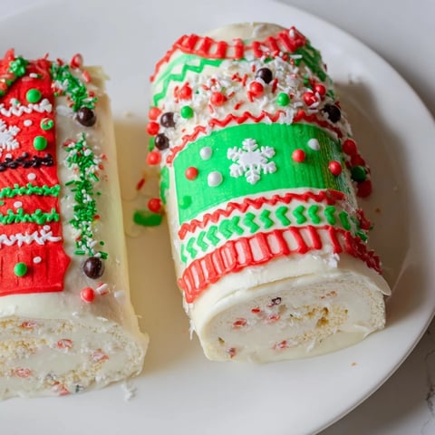 Festive Ugly Sweater Cake Roll, a colorful holiday dessert frosted with sprinkles and candies, ready to serve.