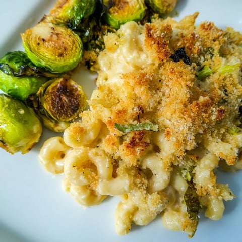 Golden, bubbly sheet pan mac and cheese with roasted Brussels sprouts, ready to serve.