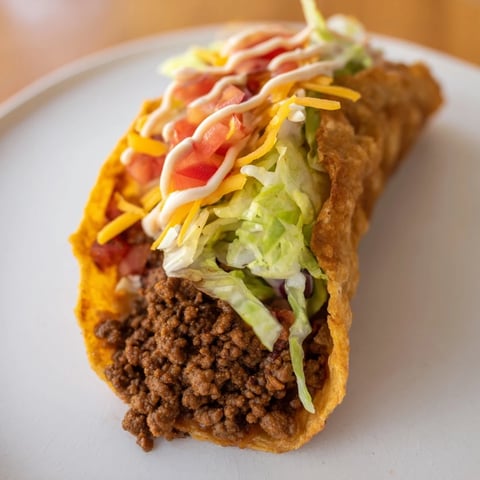A close-up of delicious Cheesy Gordita Crunch Tacos, layered with seasoned beef, cheese, and fresh toppings.