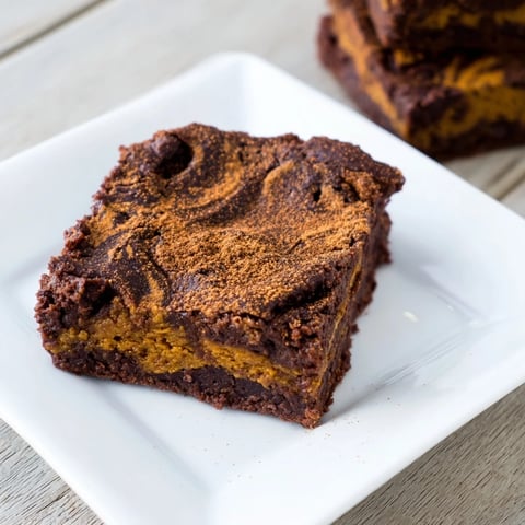 Warm, fudgy Pumpkin Workout Brownies, just pulled from the oven, offering a delightful treat.