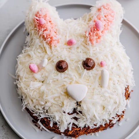 Moist Spring Bunny Carrot Cake decorated with fluffy cream cheese frosting and coconut fur.