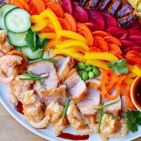 Vibrant Lunar New Year Dragon Platter with colorful peppers, shrimp, and savory BBQ pork.
