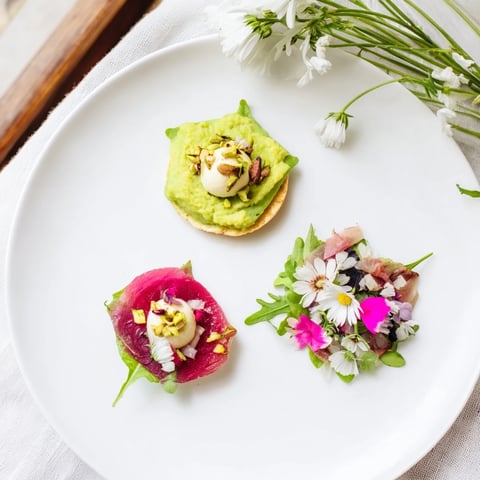 Lucky Clover Seasonal Starters plated beautifully, featuring pea purée, beet carpaccio, and goat cheese mousse.