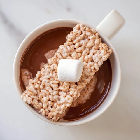 Steaming mug of hot chocolate topped with a cozy bear marshmallow bar for ultimate comfort.